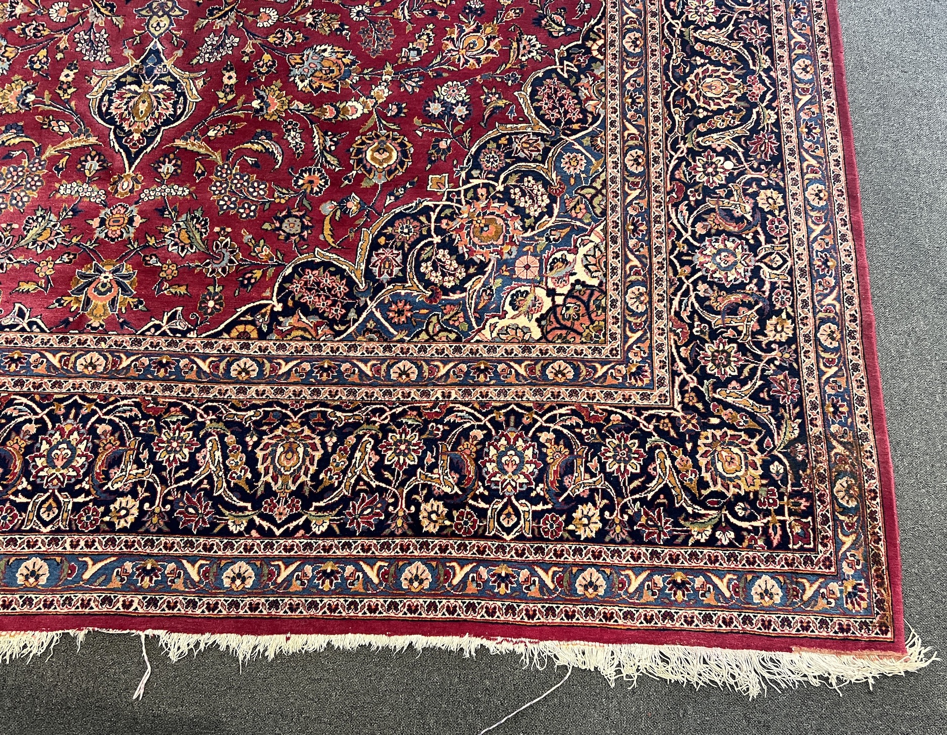 A Kashan burgundy ground carpet